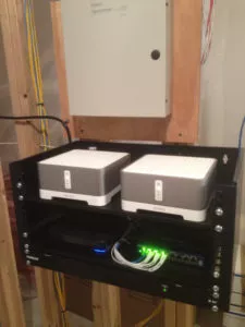 2 sonos connect in a utility room on a small rack